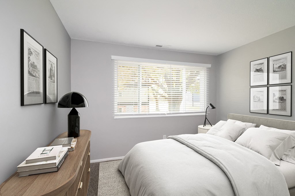 a white bedroom with a large bed and a window