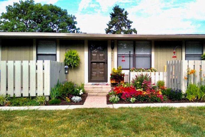 a small house with a garden in front of it