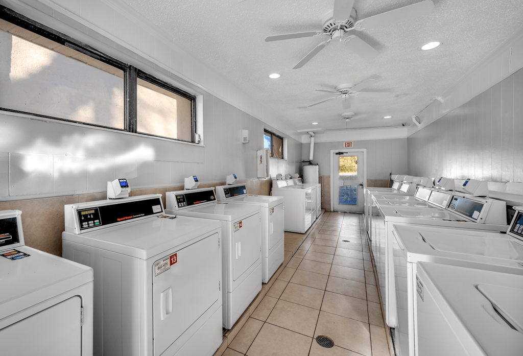 A row of washing machines in a laundromat.