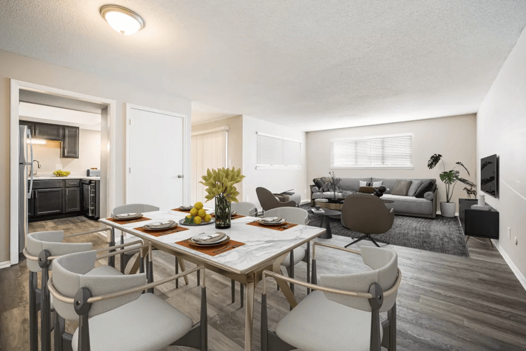 a living room and dining room with a table and chairs