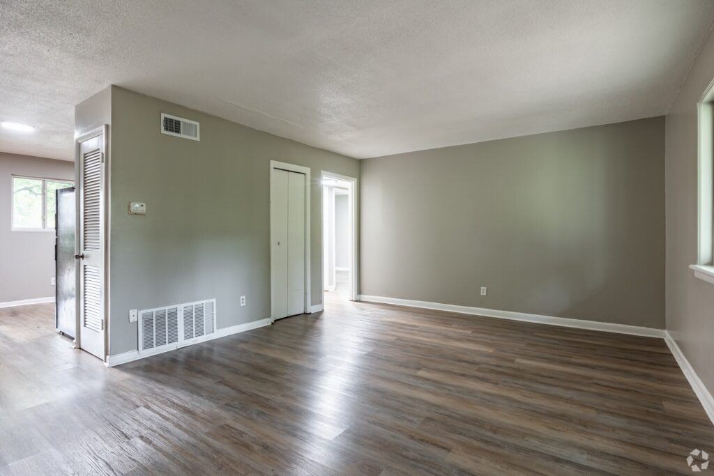 A room with wood flooring and a white ceiling.