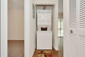 Laundry room with a washer and dryer at Aqua Bay Apartments in Naples, FL 34116