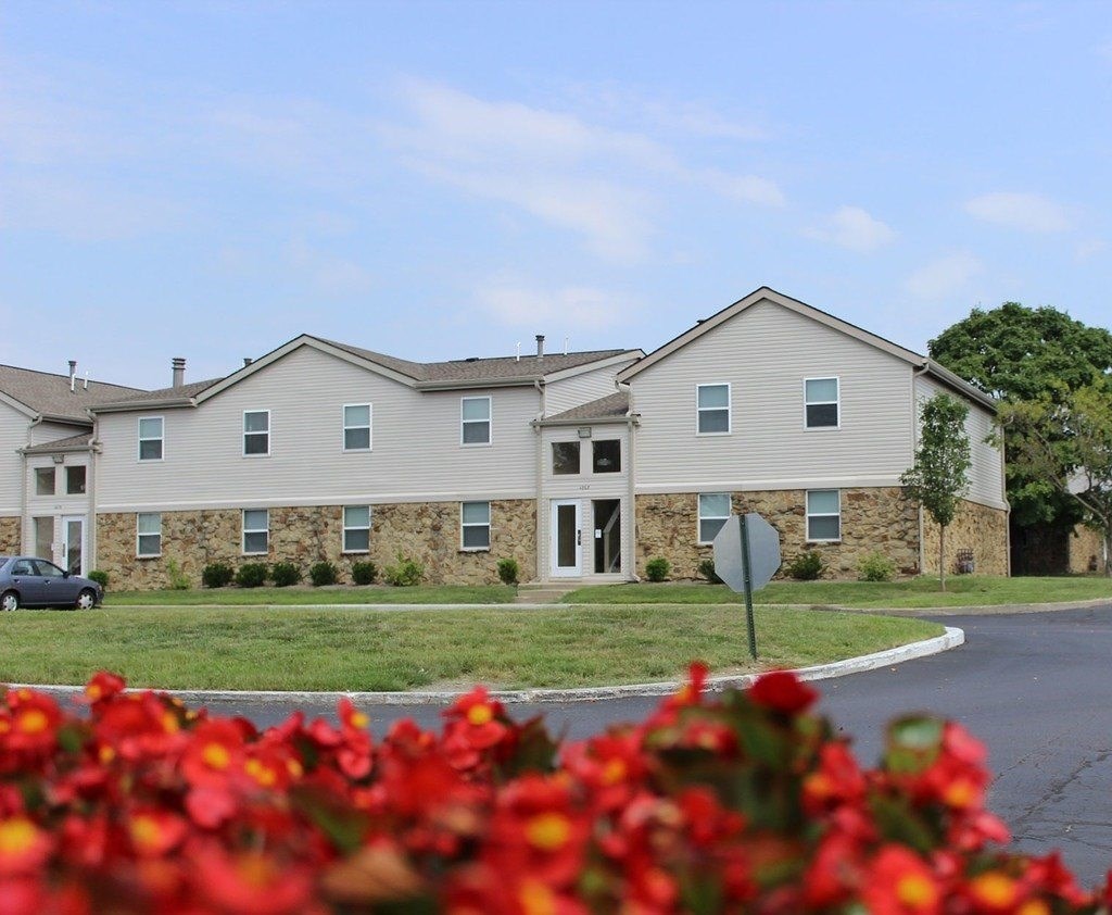 A building with a grey facade and a car parked in front.