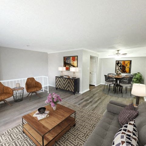 Spacious living room next to the dining area and the stairs leading to the bottom level. 