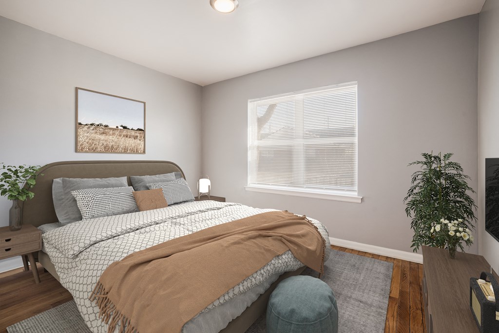 a bedroom with a bed and a chair and a window