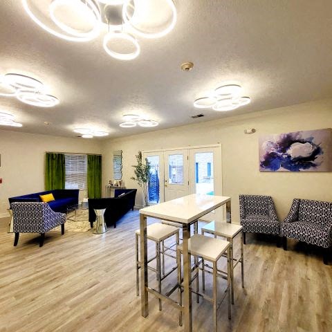 a room with a table and chairs and a couch
