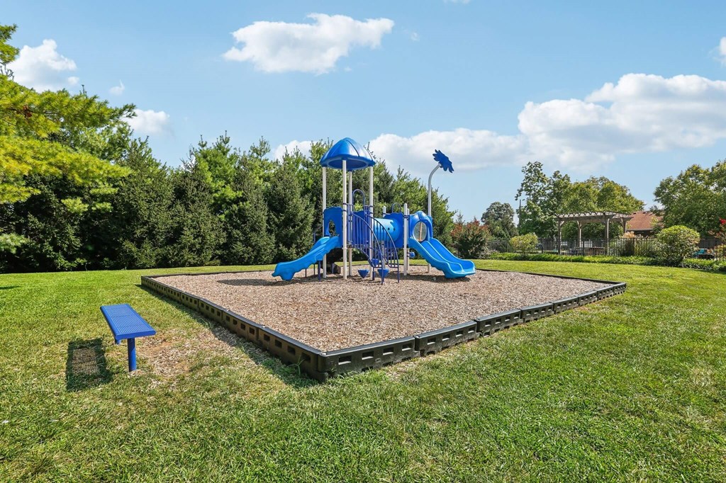 A playground with a blue slide and a blue and white tower.