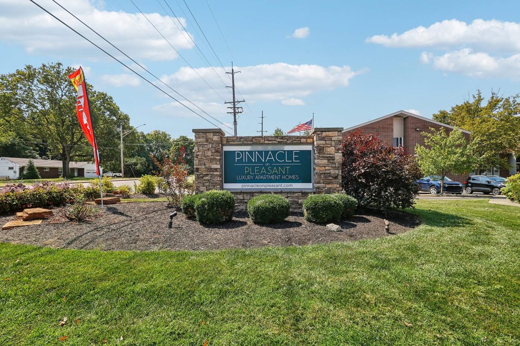 A sign that says "Pinnacle" is in front of a building.