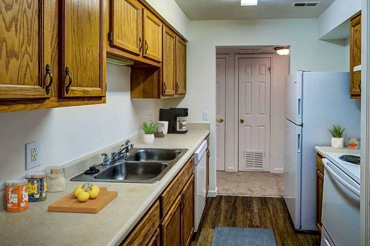 a kitchen with a sink and a refrigerator