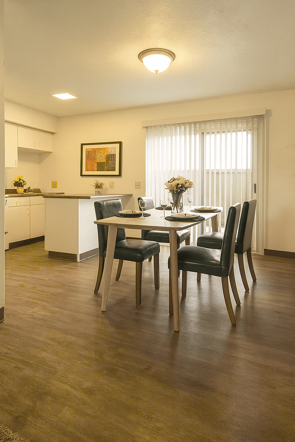 A dining room with a table set for four.