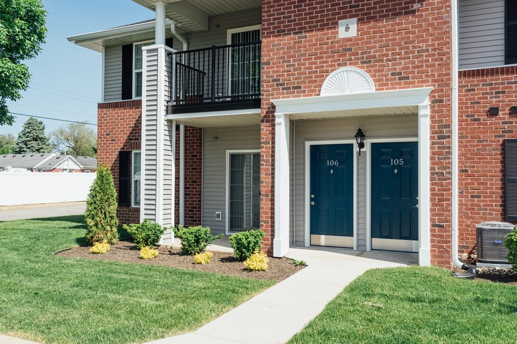 the view of the front of a brick building with blue doors
