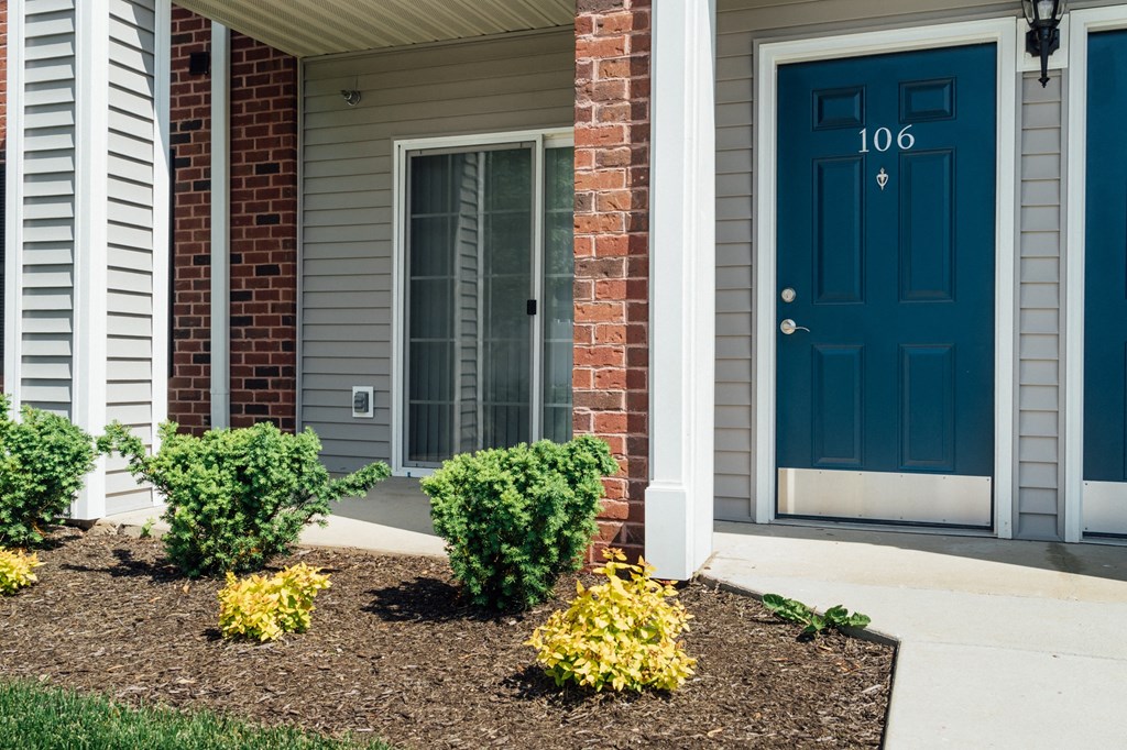 the front of a house with a blue door