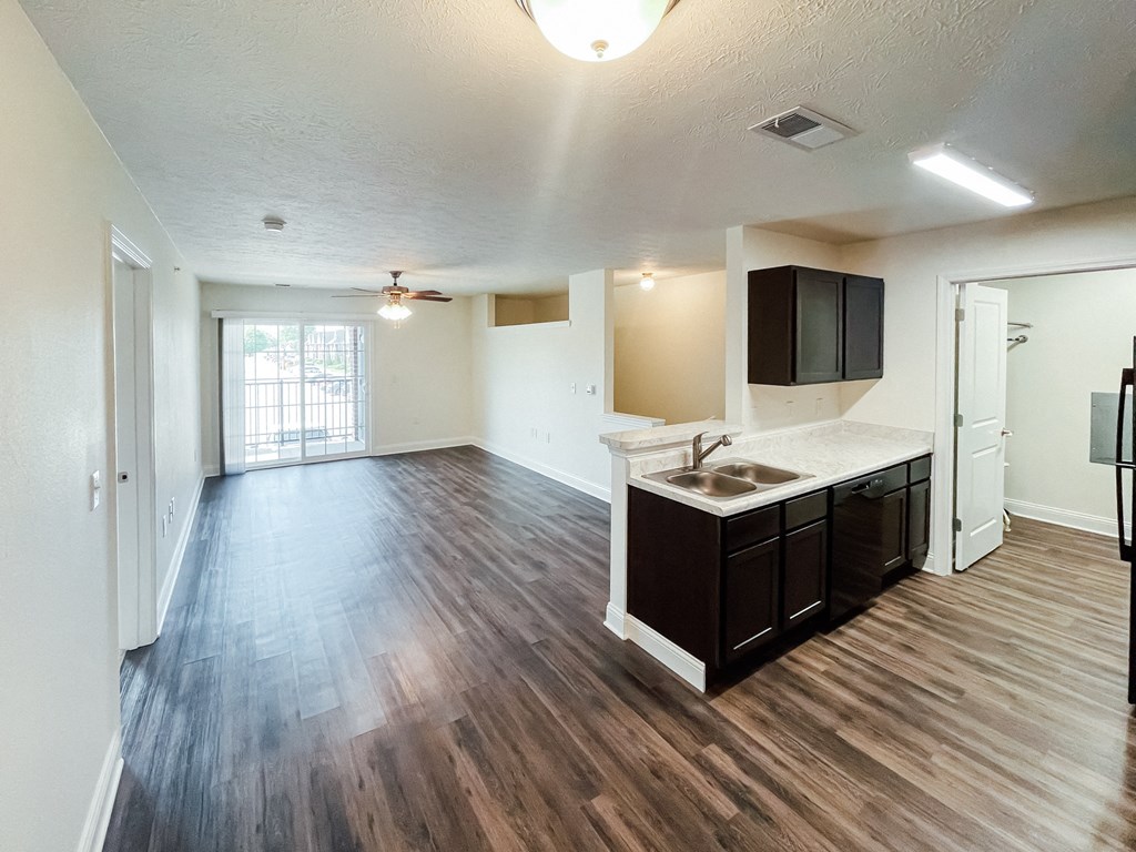 an empty living room and kitchen in an empty apartment