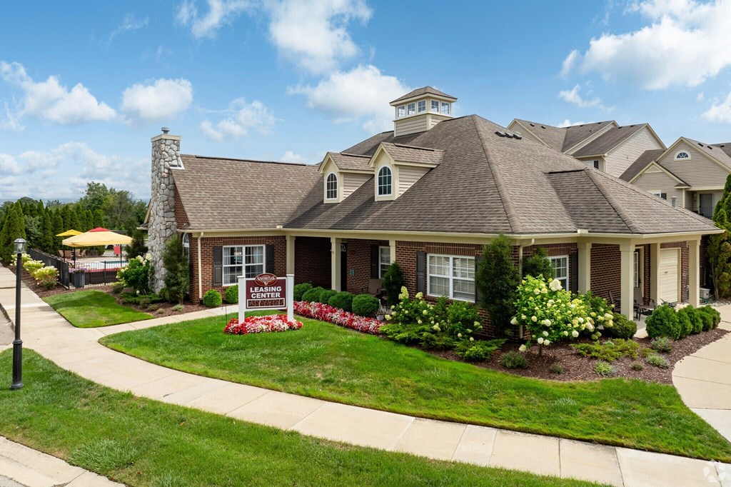 A house with a sign in front of it.