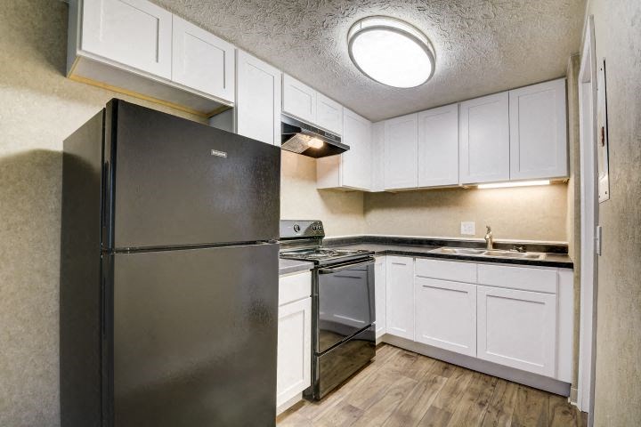 a kitchen with a refrigerator stove and sink