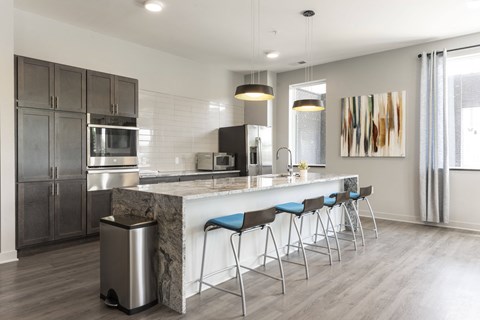 a kitchen with a marble counter top and bar stools
