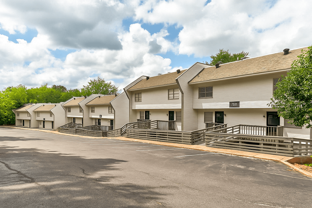 A row of white houses with black railings.