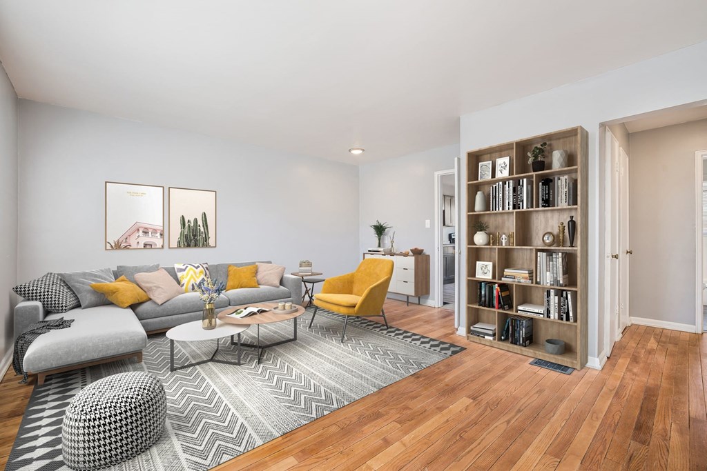 a living room with a couch and a book shelf