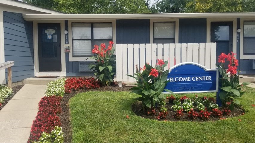 a blue and white sign in front of a house