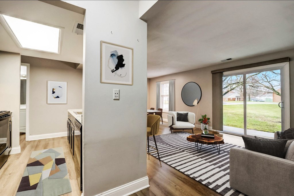 a living room with a couch and a rug and a sliding glass door