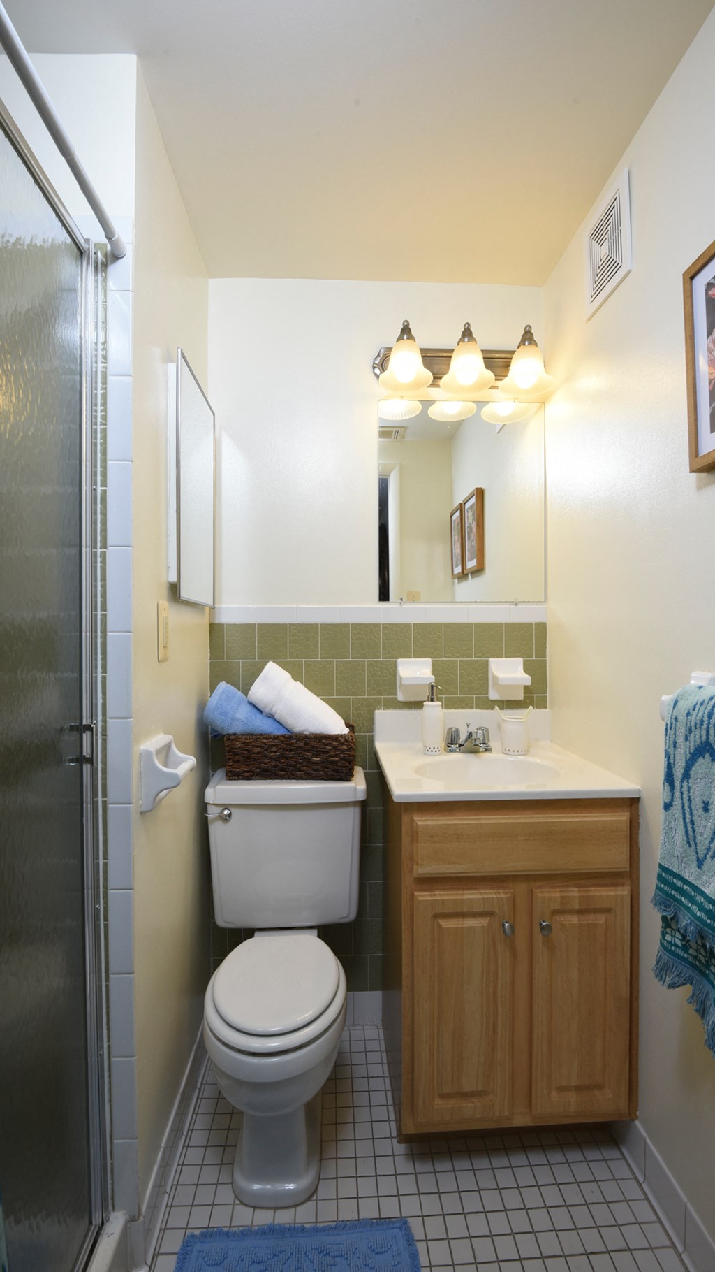 Bathroom with toilet and sink above cabinet at Village of Pine Run Apartments & Townhomes*, Maryland