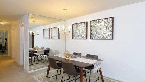 dining room with a dining table and chairs and a wall with artwork at Village of Pine Run Apartments & Townhomes*, Maryland, 21244