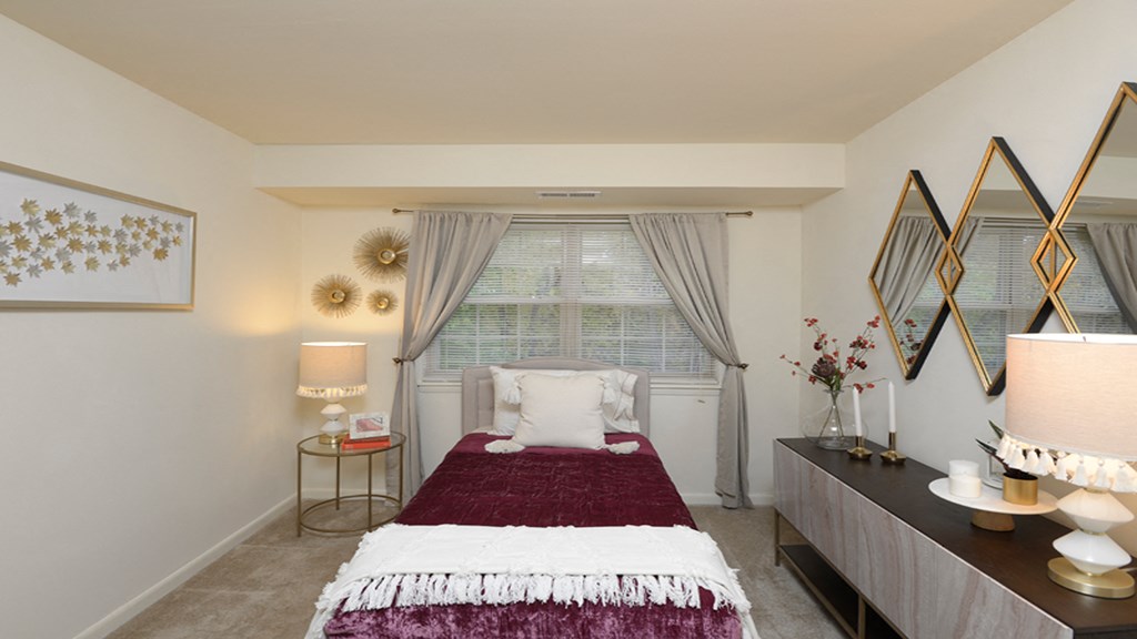 bedroom with a bed and a large window at Village of Pine Run Apartments & Townhomes*, Maryland, 21244