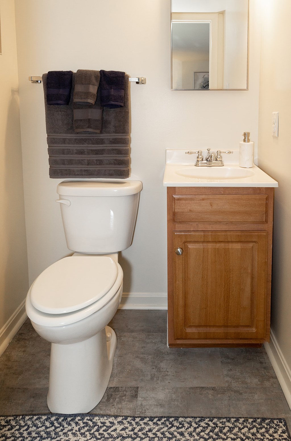 A white toilet sits next to a sink in a bathroom.