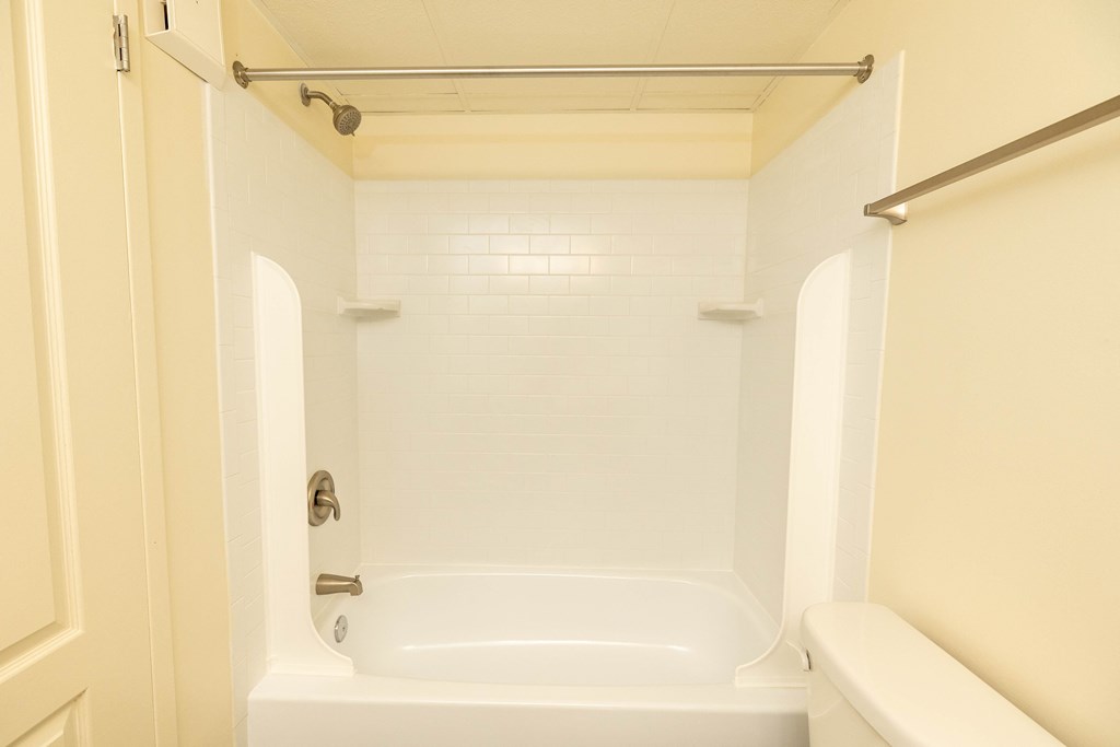 Bathroom with a white tub and a white toilet  at Charlesgate Apartments, Maryland, 21204