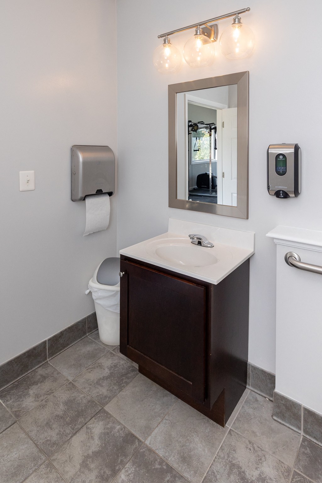 Bathroom with a sink and a mirror and a toilet  at Cromwell Valley Apartments, Towson, MD