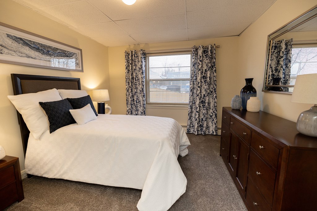 Bedroom with a bed and a dresser at Loch Bend Apartments, Baltimore, MD.