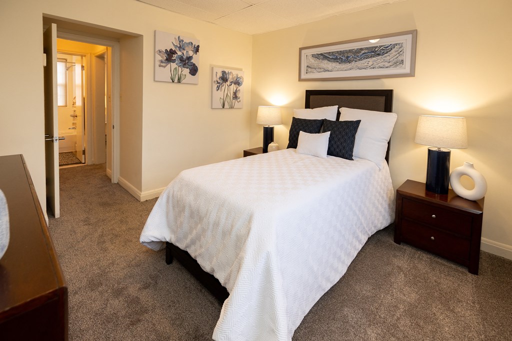 Bedroom with a large white bed at Loch Bend Apartments, Baltimore, MD, 21234.