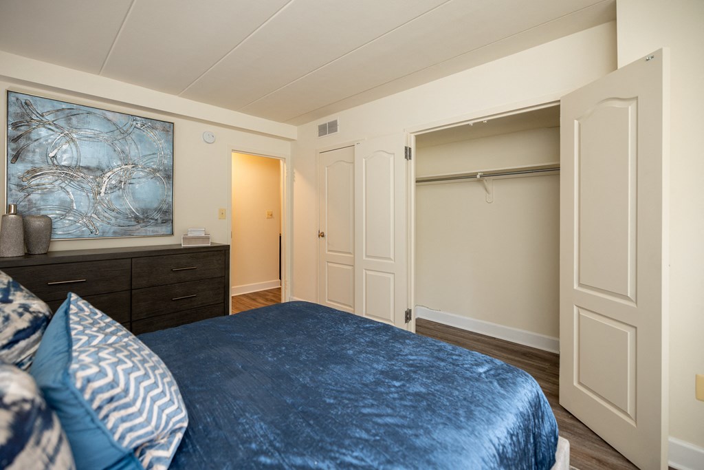 Bedroom with a large bed and a closet at Ivy Hall Apartments*, Towson, Maryland.