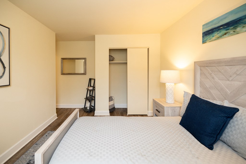 Bedroom with a large bed and a closet at Rockdale Gardens Apartments*, Baltimore, MD