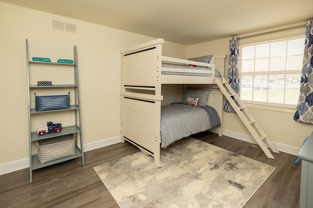 A bedroom with a bunk bed and a ladder.at Chapel Valley Townhomes, Nottingham