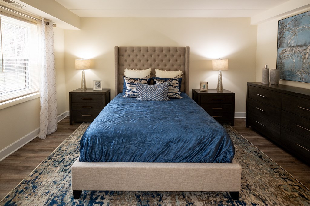 Master bedroom Bedroom with a bed and dressers at Ivy Hall Apartments*, Towson, MD 21204.