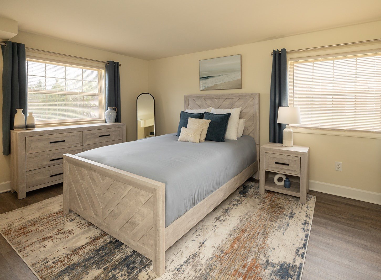A bedroom with a large bed, nightstands, and a rug at Security Park Apartments*, Maryland, 21244