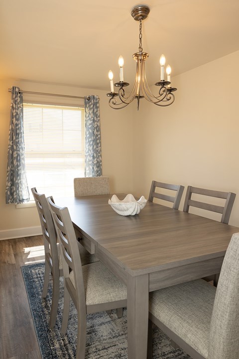 Dining room with window , hanging light fixture, and dining room table