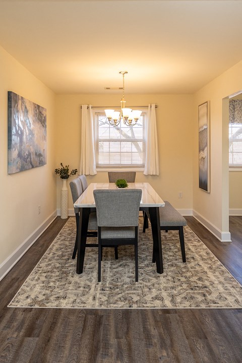 A dining room with a table and chairs at Liberty Gardens Apartments, Baltimore, MD
