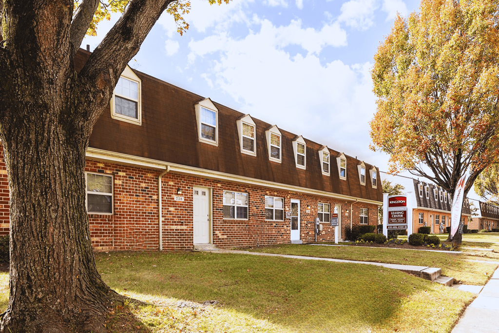 A brown building with a white door and windows.