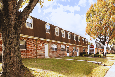 A brown building with a white door and windows.