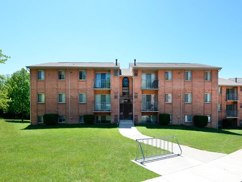Three story brick apartment building with balconies at Lawyers Hill Apartments, Maryland, 21075