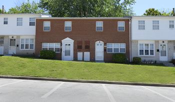 A row of houses with a white garage door in the middle.