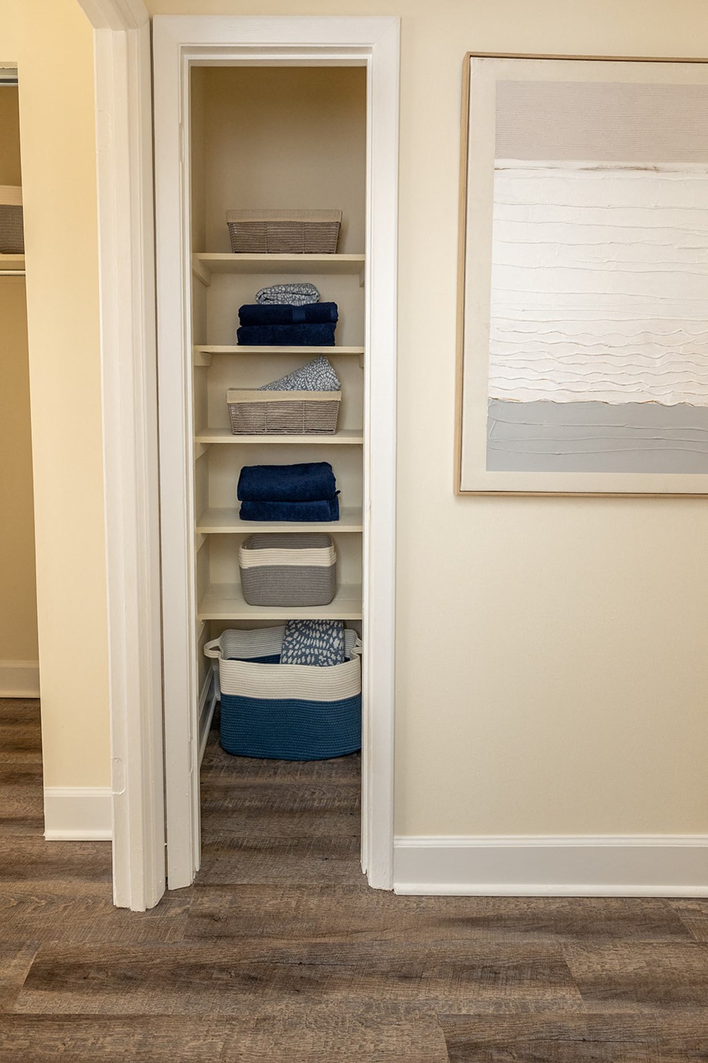 A linen closet with shelves and baskets at Liberty Gardens Apartments, Baltimore, MD, 21244