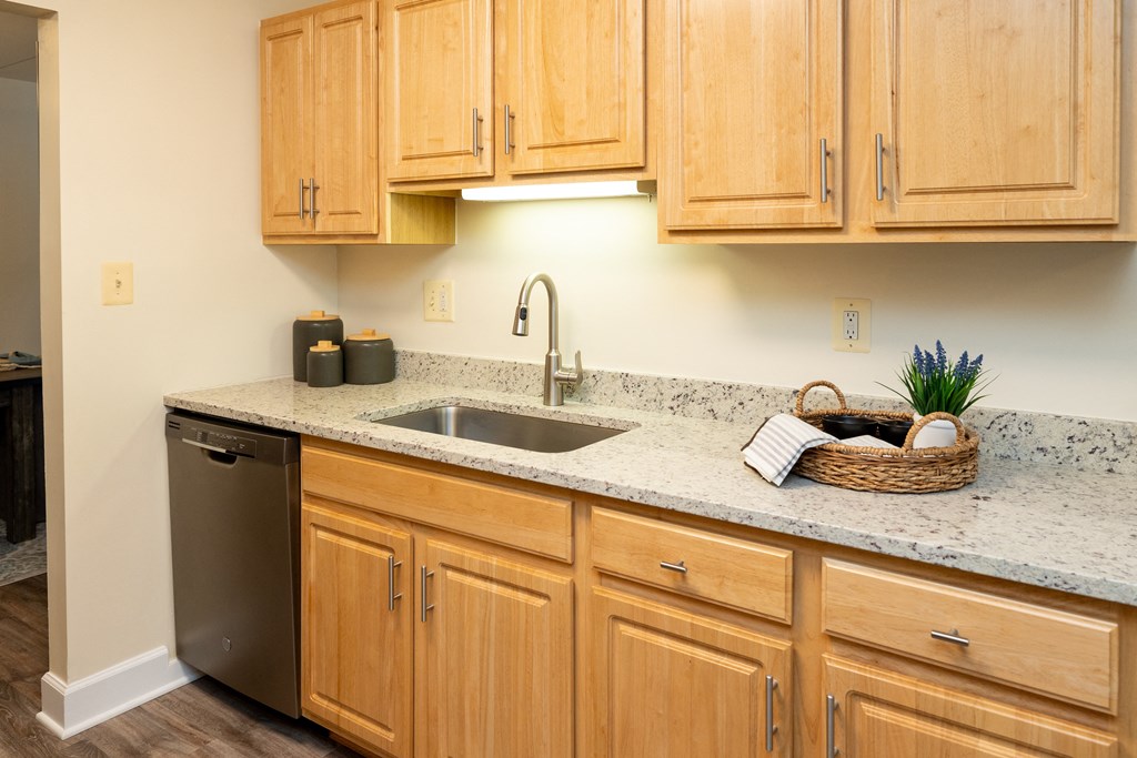 Kitchen with wooden cabinets and granite counter top at Ivy Hall Apartments*, Towson