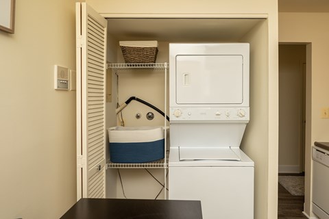 A small kitchen with a washing machine and a dishwasher.