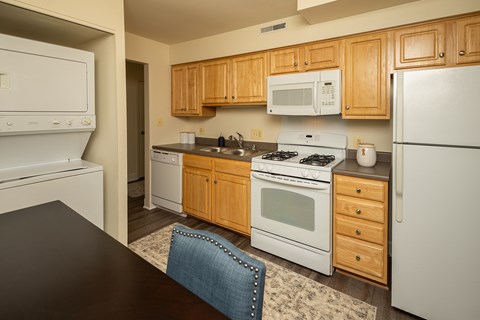 A kitchen with wooden cabinets and white appliances.