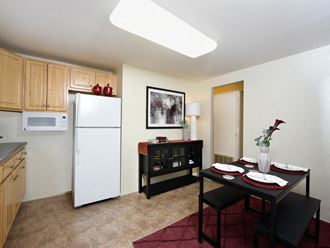 a kitchen and dining area in a 555 waverly unit - Photo Gallery 5