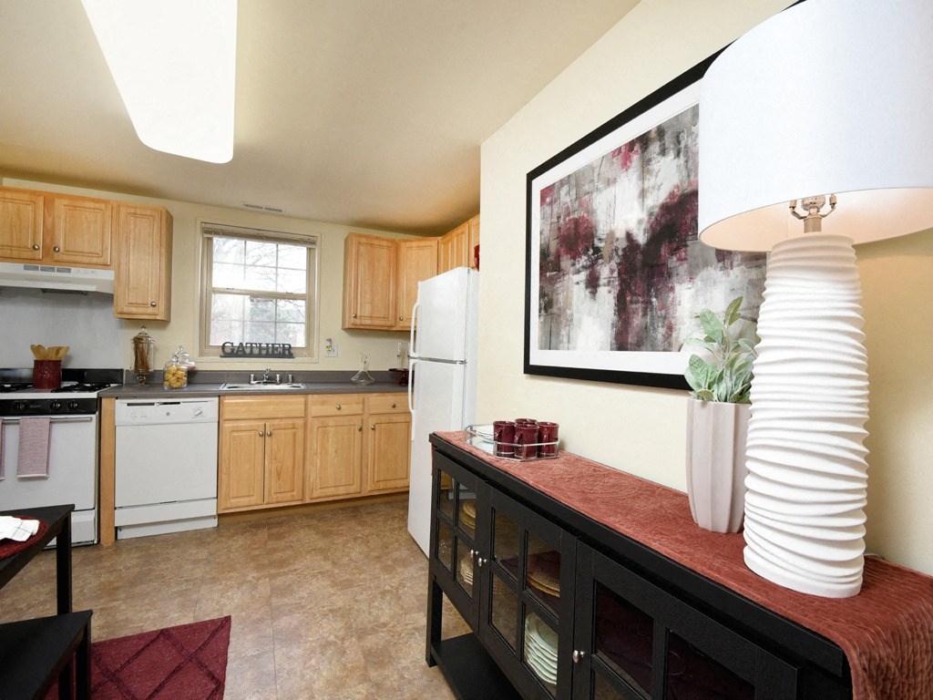 Kitchen with white appliances and a large painting on the wall at Hyde Park Apartments*, Essex Maryland
