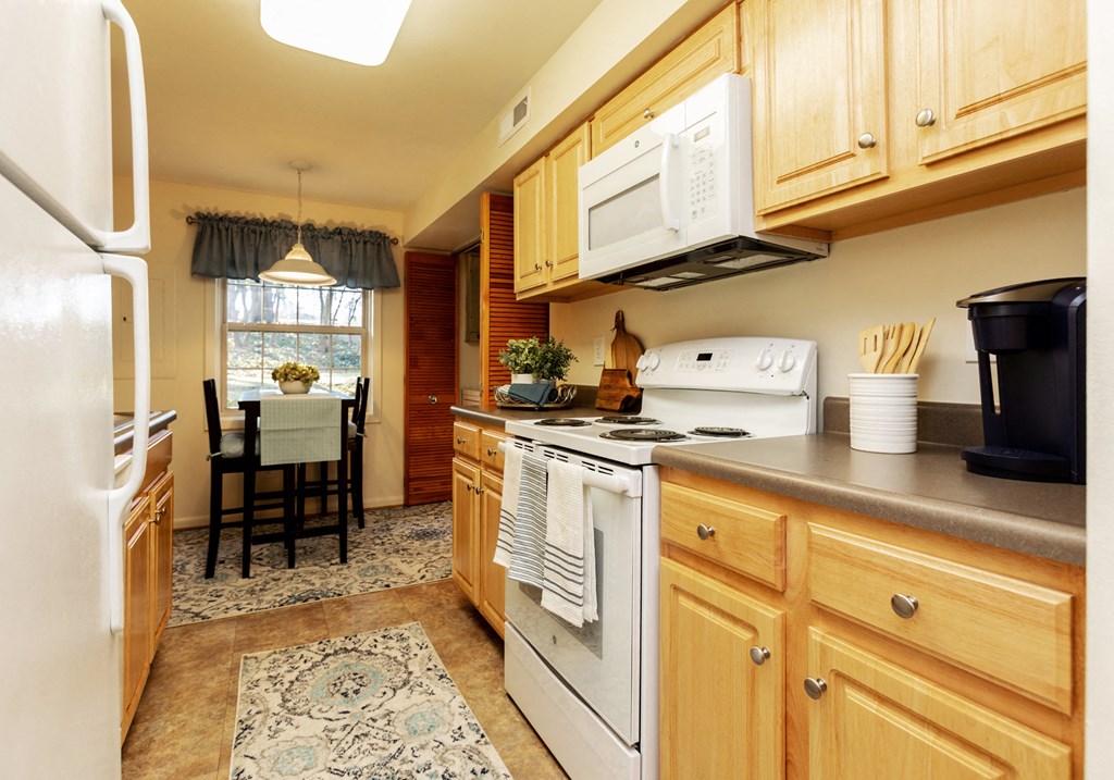 Large eat in kitchen with washer and dryer in unit at Spring Hill Apartments & Townhomes, Baltimore, MD 21234